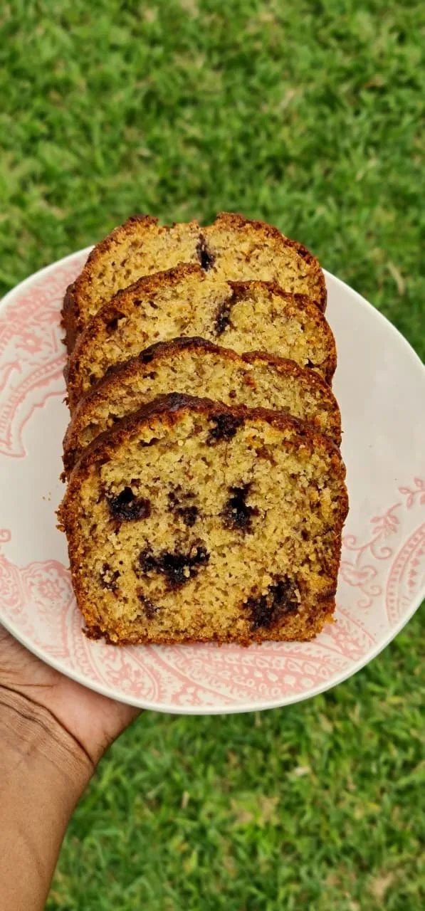 Slices of chocolate chip banana bread on a pink plate