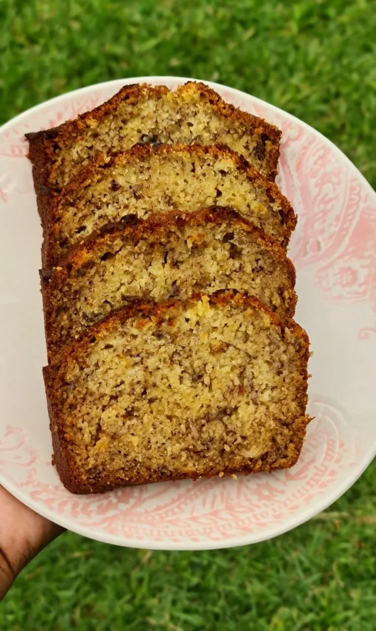 Banana bread slices fanned on a paisley plate
