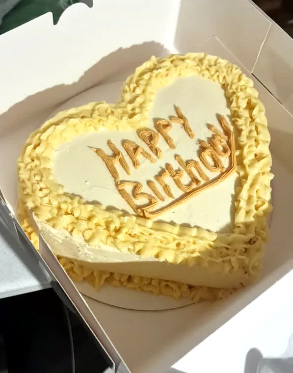 Heart-shaped Happy Birthday cake in a cake box