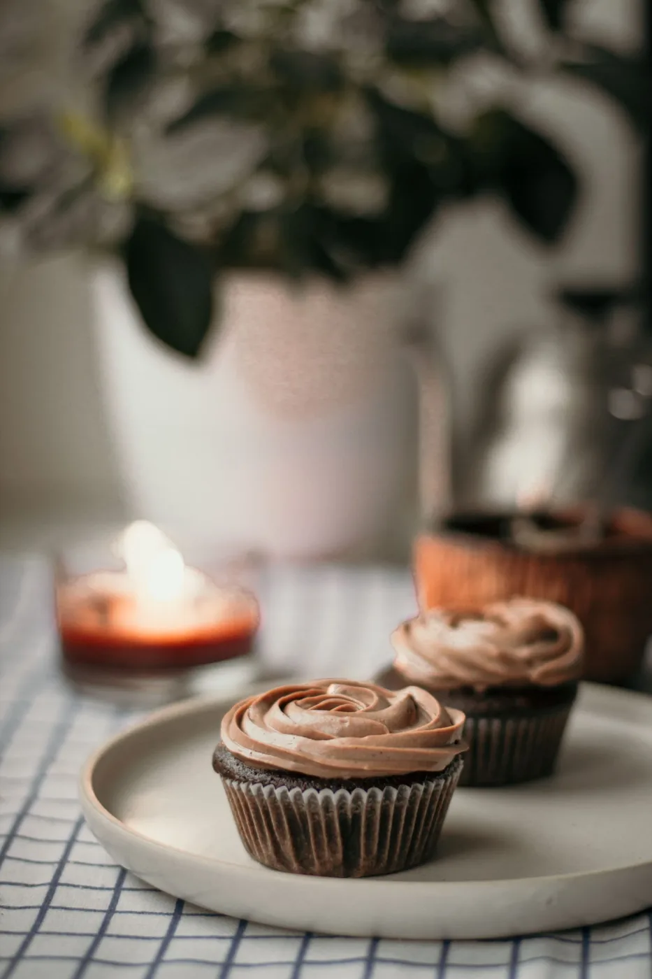 Chocolate cupcakes with swirled chocolate frosting on a plate